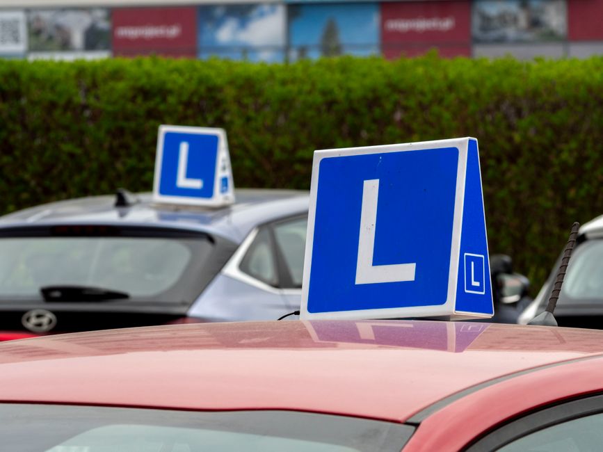 Driving school car on a UK road, ready for a lesson.