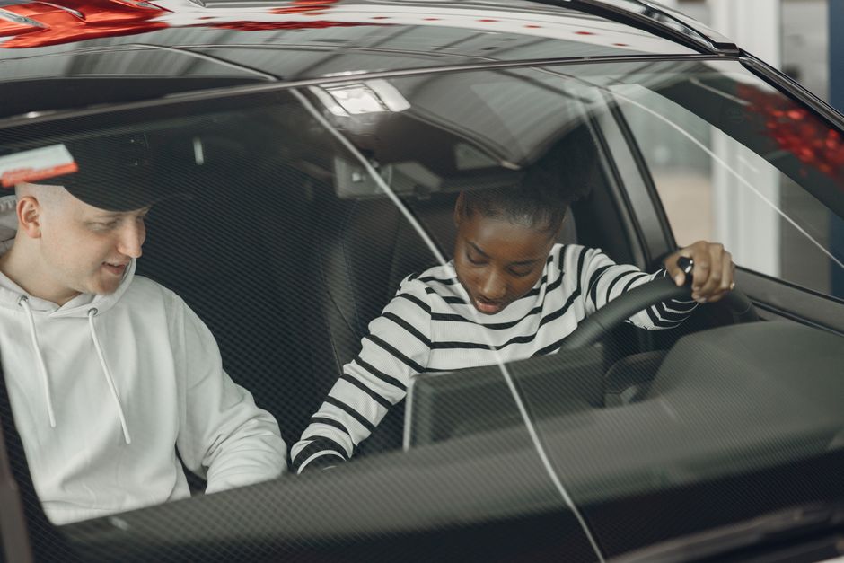 Driving instructor coaching a learner driver during a driving lesson.